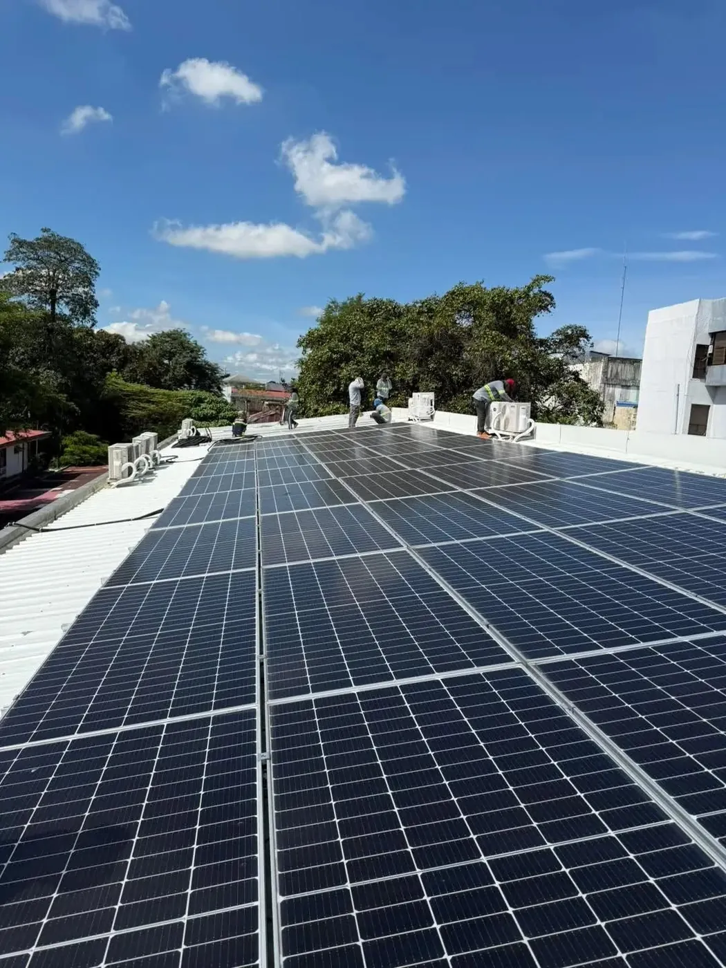 Rooftop solar array: Crew fitting a rooftop PV array.