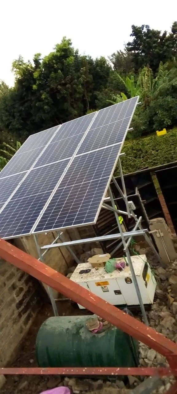 Solar with generator backup: Solar array alongside a canopy generator and fuel tank.